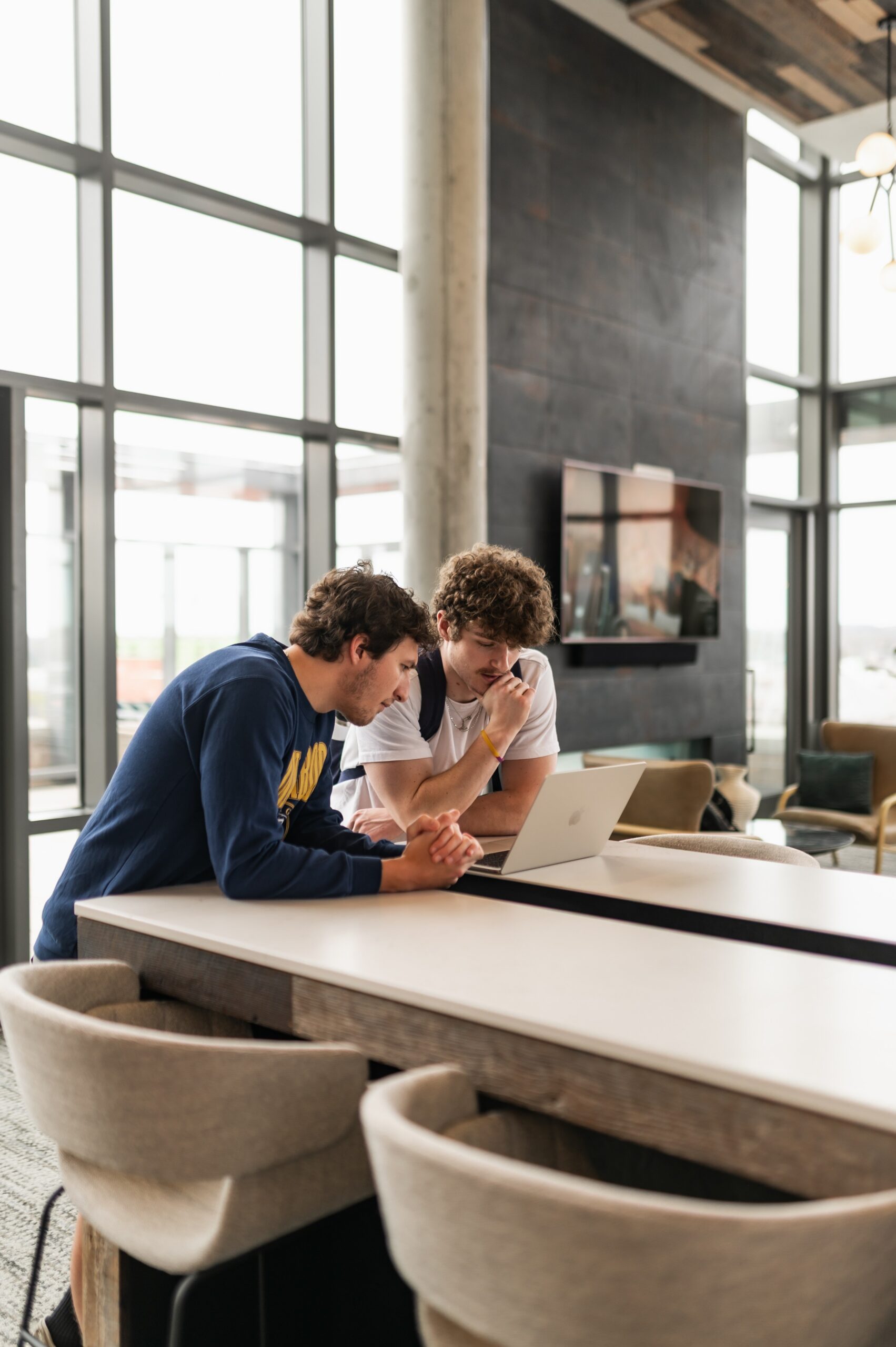 Two friends studying together in the penthouse lounge at Six11